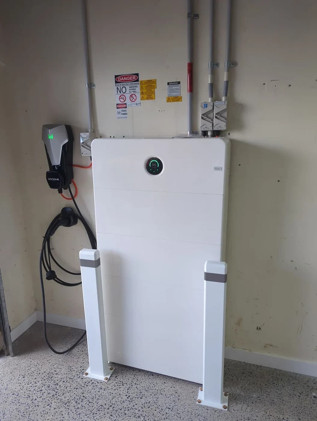 GoodWe HCA EV charger installed beside a home battery system protected by bollards